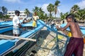 Fisherman collecting fish from their nets on Arugam Bay beach in Sri Lanka.