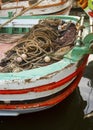 Fisherman complected net on small wooden boat Royalty Free Stock Photo