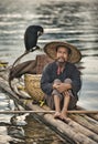 Fisherman with cormorants on the river Lijiang Royalty Free Stock Photo