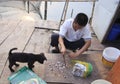 Fisherman cut fish food to feed the dog