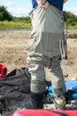 Fisherman donning a pair of waders