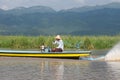 Fisherman driving in wooden boat on inle lake in myanmar asia