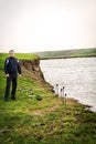 Fisherman at the edge of the lake upset Royalty Free Stock Photo