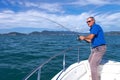 Fisherman fighting big fish on the ocean from the boat Royalty Free Stock Photo