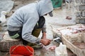 Fisherman filleting fish with knife, Essaouira, Morocco Royalty Free Stock Photo