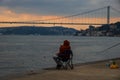 fisherman fishes on Bosphorus Istanbul on a Foggy sunrise