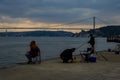 fisherman fishes on Bosphorus Istanbul on a Foggy sunrise