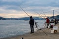 fisherman fishes on Bosphorus Istanbul on a Foggy sunrise