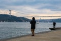 fisherman fishes on Bosphorus Istanbul on a Foggy sunrise