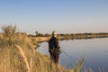 Fisherman fishes spinning on the river bank Royalty Free Stock Photo