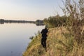 Fisherman fishes spinning on the river bank Royalty Free Stock Photo