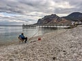 Fisherman is fishing on the Black Sea coast in Koktebel in the C