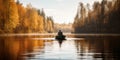 fisherman fishing from the boat in the lake on sunny autumn day Royalty Free Stock Photo