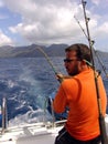 Fisherman fishing on boat in ocean on Seychelles