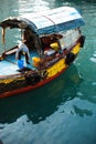 Fisherman fishing bucket in a old boat, in Hong Kong