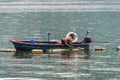 Fisherman fishing clams in Hong Kong under the rain Royalty Free Stock Photo