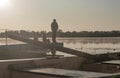 Fisherman fishing in foggy morning. Man silhouette resting with rod on river or lake in mist Royalty Free Stock Photo