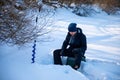 A fisherman fishing in a hole in the ice to catch fish, Tom river in Kemerovo, Russia Royalty Free Stock Photo