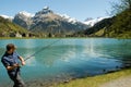 Fisherman fishing on the lake at the village of Engelberg