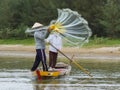 Fisherman is fishing with a large net in a river in Vietnam