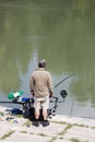 Fisherman fishing in the river Tiber