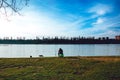 Fisherman with a fishing rod on the river bank. Cats. Blue sky Royalty Free Stock Photo