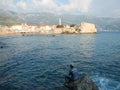 Fisherman fishing in the Small old meditarranean town in montenegro Royalty Free Stock Photo