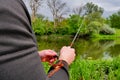 Fisherman is fishing on a spinning. Fisherman`s hands with a fishing rod Royalty Free Stock Photo