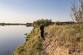 Fisherman fishes spinning on the river bank Royalty Free Stock Photo