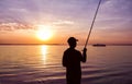 Fisherman fishing on sunset Royalty Free Stock Photo