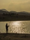 fisherman fishing at sunset Royalty Free Stock Photo