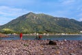 The fisherman fixes the bait on his fishing pole on the beach of Manzanillo Colima. Royalty Free Stock Photo