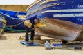 Fisherman fixing his boat, port of Essaouira