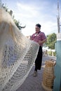 Fisherman fixing his nets