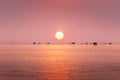 Fisherman and floating village in the ocean on sunrise