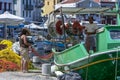 A fisherman and friend check fishing nets for holes in the harbour of the Greek island of Kastellorizo.