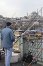 Fisherman on Galata bridge on the background mosque Suleiman. Istanbul