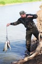 Fisherman gets out of the catch Royalty Free Stock Photo