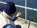 Fisherman grafts into the hook a Korean worm