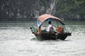 Fisherman in Ha Long Bay, Fish boat in wonderful landscape of Ha long Bay, Vietnam Royalty Free Stock Photo