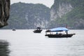 Fisherman in Ha Long Bay, Fish boat in wonderful landscape of Halong Bay, Vietnam Royalty Free Stock Photo