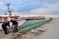 Rimini, Italy, November 19, 2010: Fisherman on a harbor with net in hands