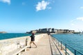 Fisherman on the harbor wall jetty in the historic French town of Saint-Malo