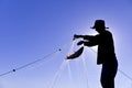 Fisherman hauling catch in net Royalty Free Stock Photo