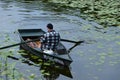 A fisherman in his boat at lake in Poland