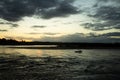 A Fisherman in his boat during sunset Royalty Free Stock Photo