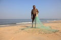 A fisherman hold his fishing net