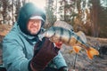 Fisherman holding bass in hand