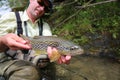 Fisherman holding brown trout