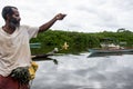 Fisherman holding fishing line with fish on hook.